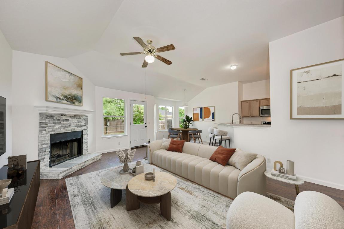 a living room with furniture fireplace and a table