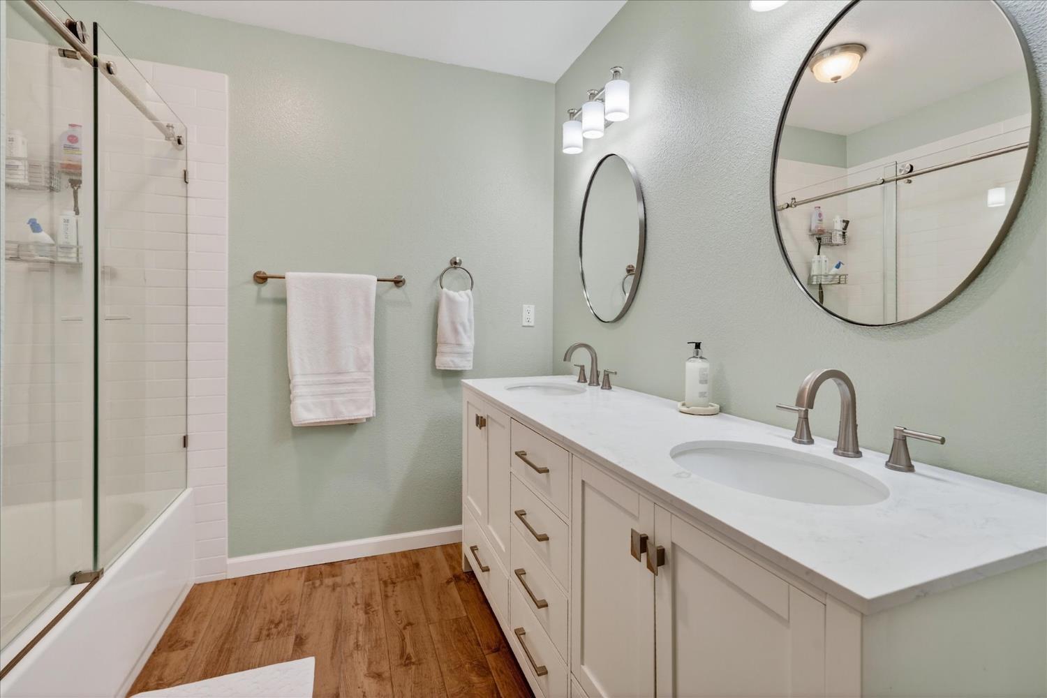 47482 Veater Ranch Road Coarsegold, CA 93614 - Photo 24 of 51 a spacious bathroom with a double vanity sink and a mirror