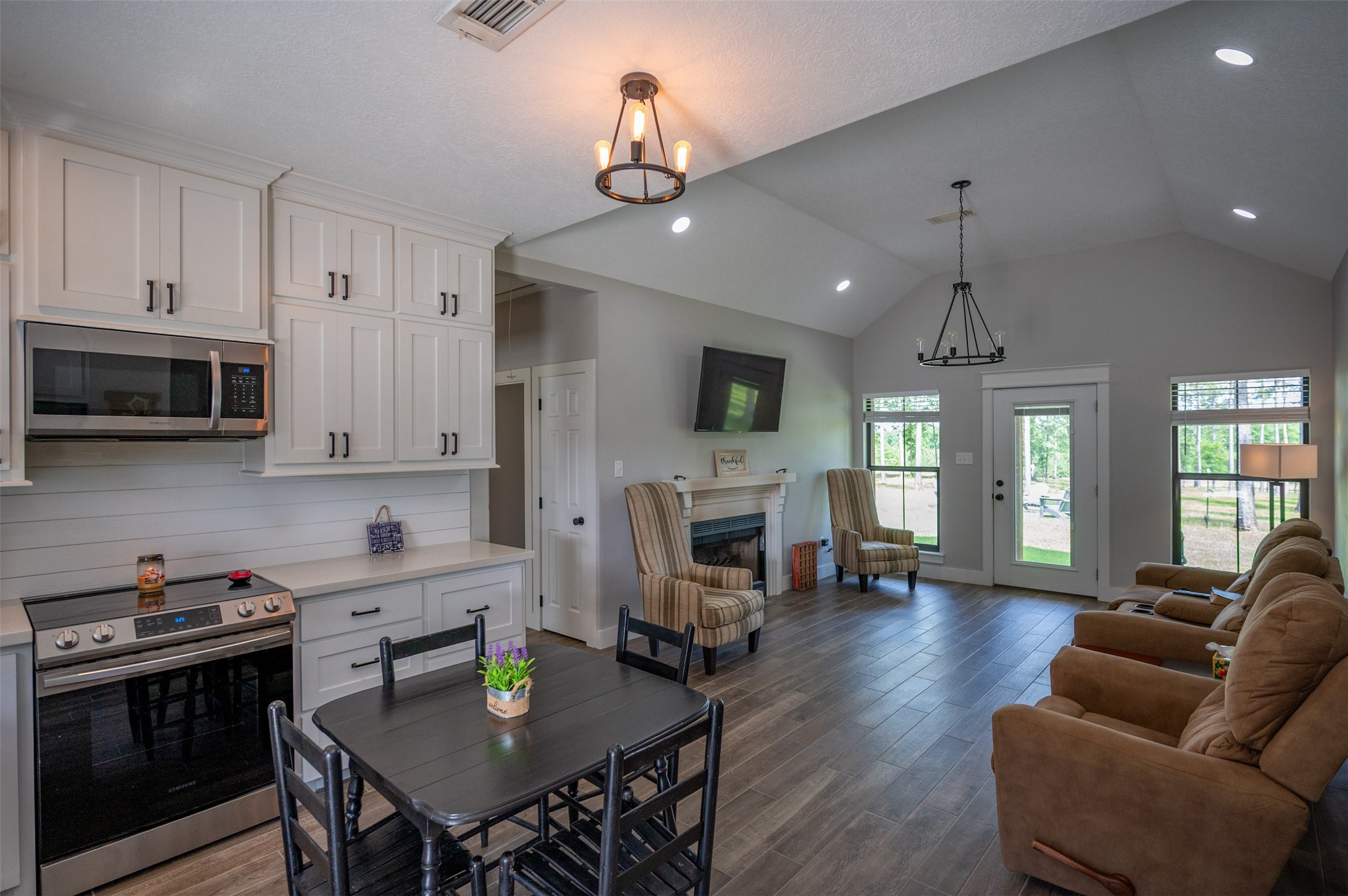 1068 County Road 3200 Colmesneil, TX 75938 - Photo 19 of 43 a kitchen with sink refrigerator stove dining table and chairs