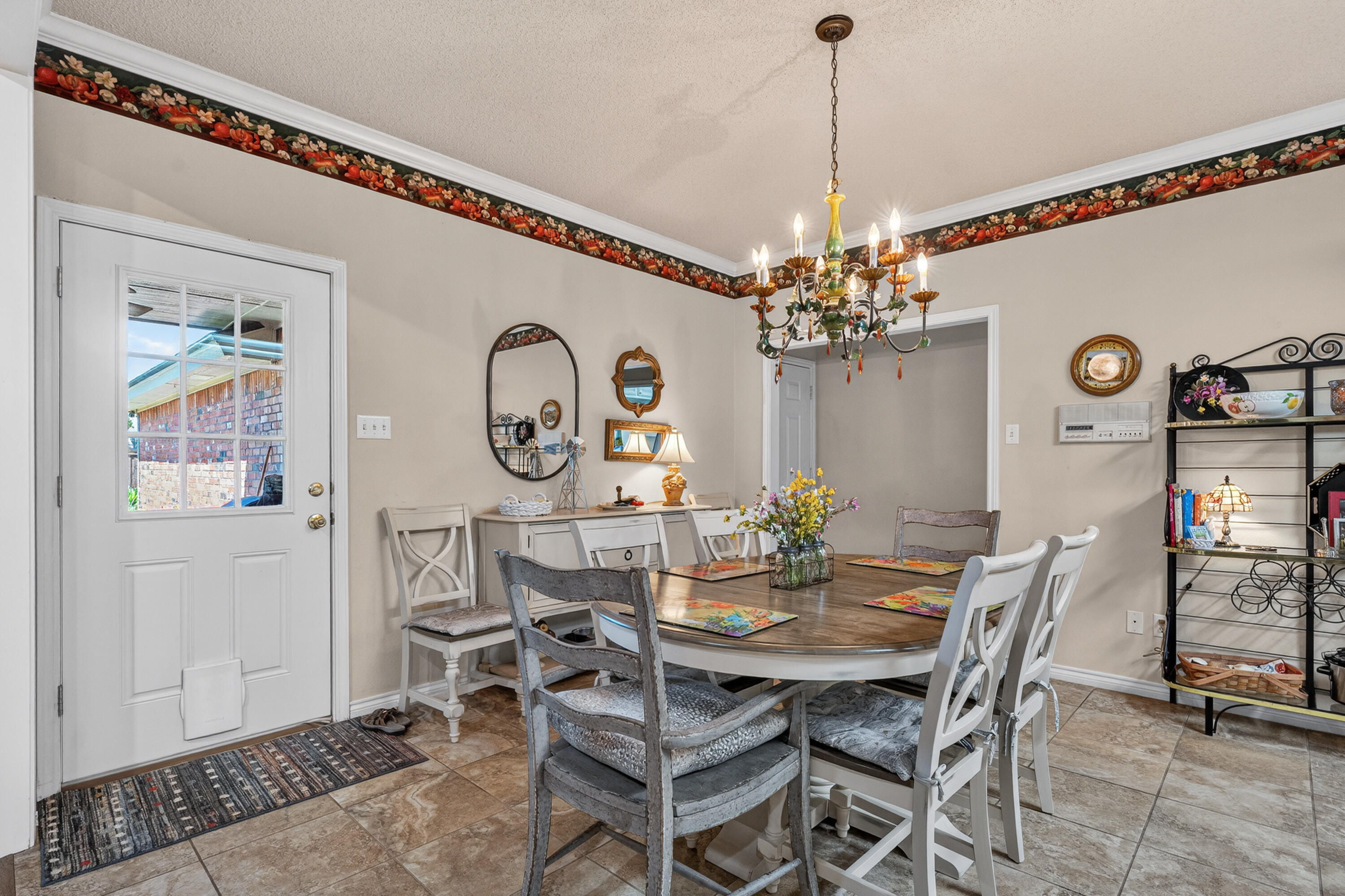 7402 95th Street Lubbock, TX 79424 - Photo 13 of 43 a view of a dining room with furniture and chandelier