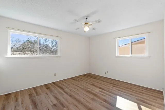 wooden floor in an empty room with a window