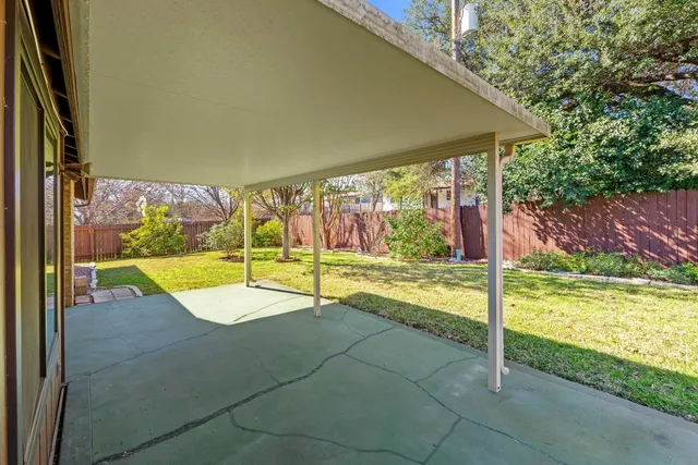 a view of a backyard with swimming pool