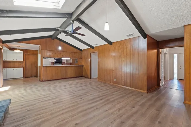a view of a kitchen with a dishwasher and wooden floor