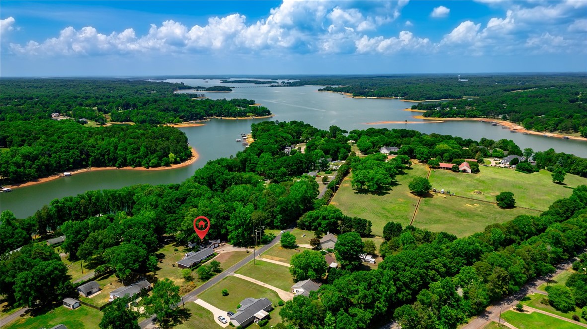 1815 Pearman Dairy Road Anderson, SC 29625 - Photo 32 of 35 A captivating aerial perspective reveals a serene lakefront community amidst verdant forests.