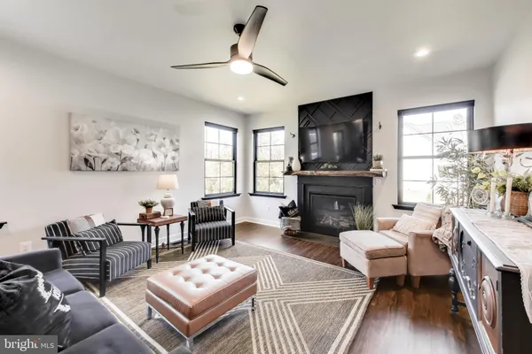 a living room with furniture a fireplace and a flat screen tv