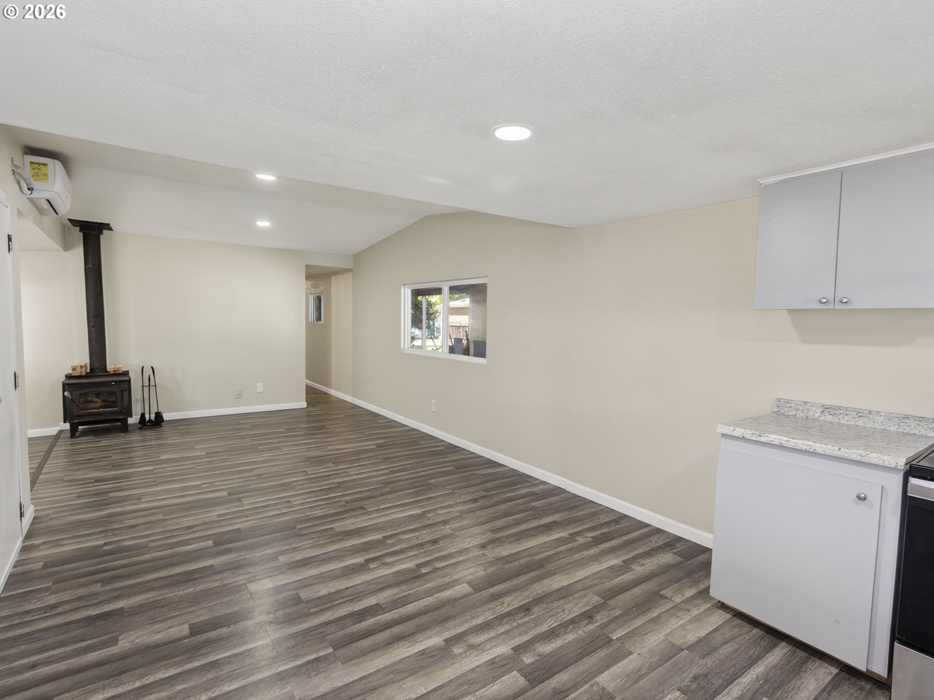 10405 Southwest Denney Road, Unit 31 Beaverton, OR 97008 - Photo 11 of 44 a view of an empty room with wooden floor and a window