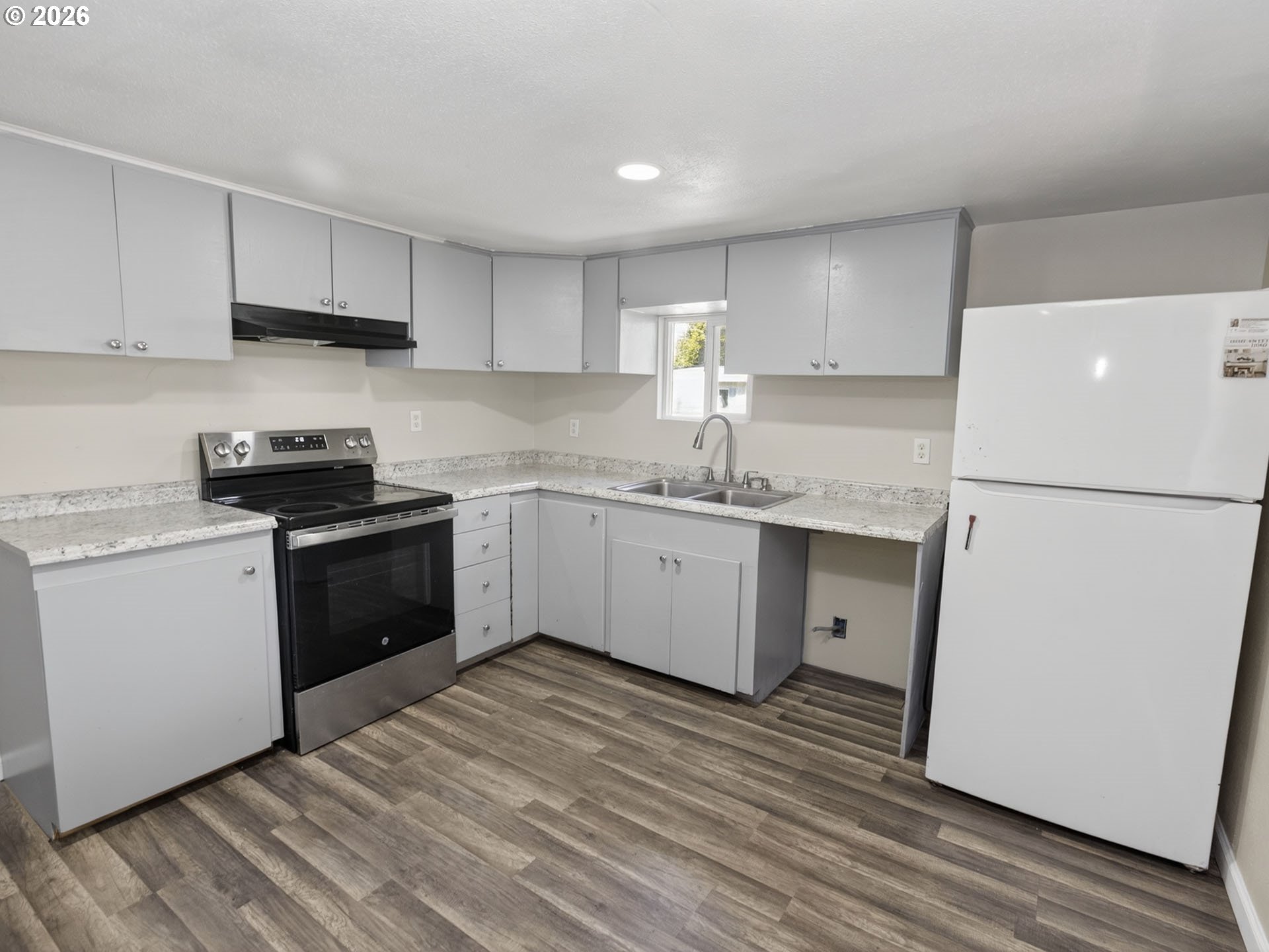 10405 Southwest Denney Road, Unit 31 Beaverton, OR 97008 - Photo 12 of 44 a kitchen with a sink a stove a refrigerator and cabinets