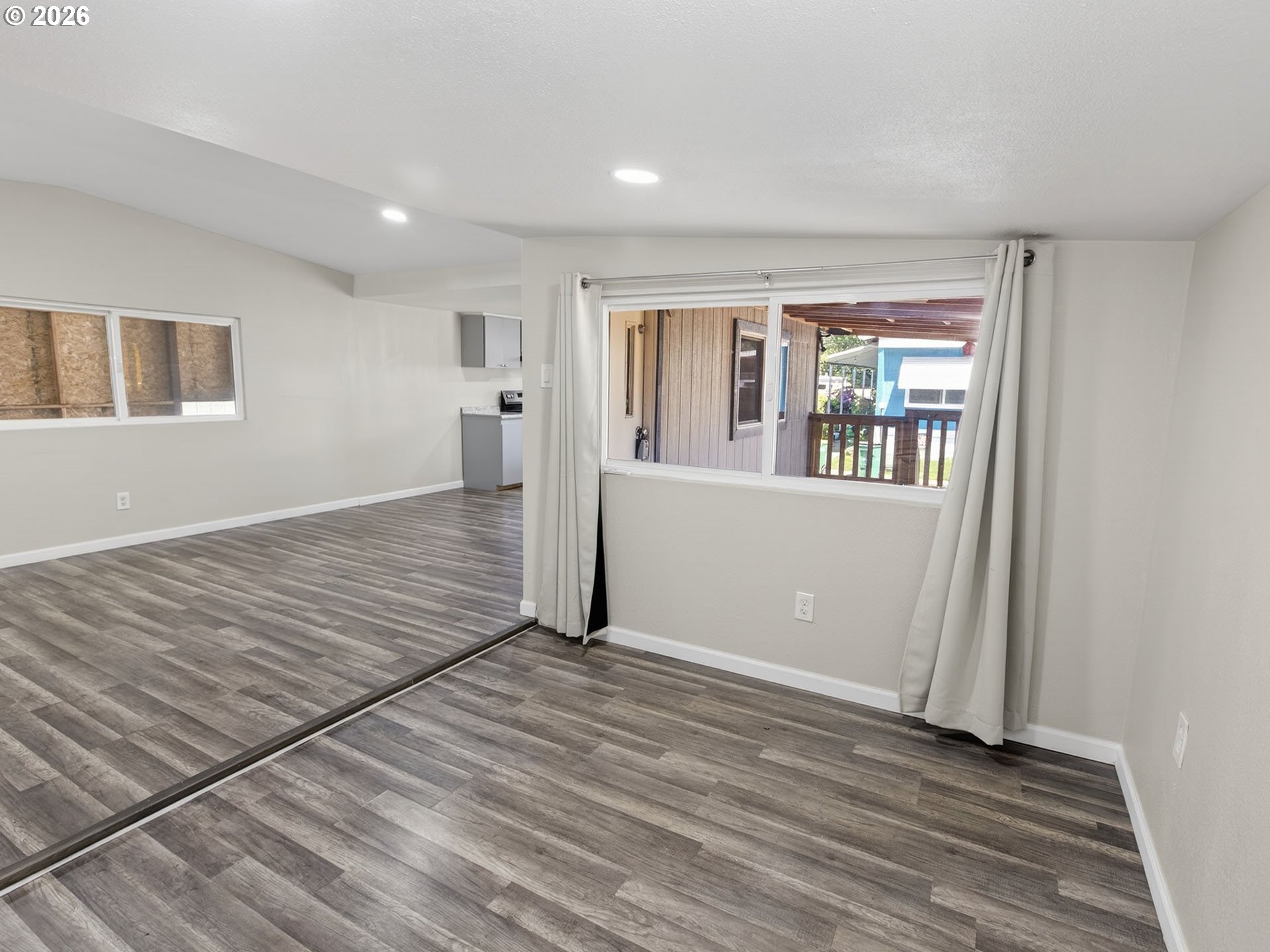 10405 Southwest Denney Road, Unit 31 Beaverton, OR 97008 - Photo 15 of 44 a view of an empty room with wooden floor and a window