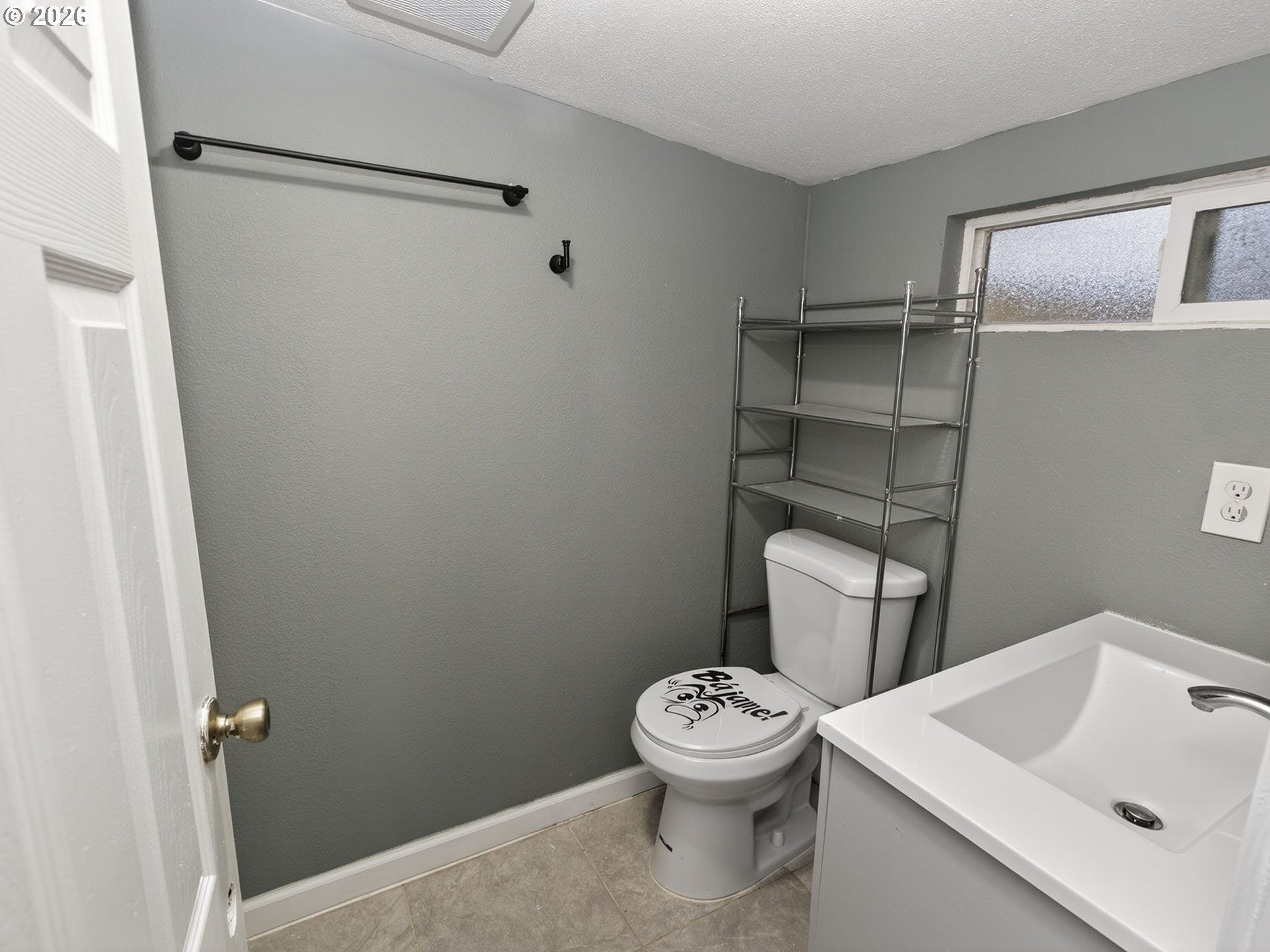 10405 Southwest Denney Road, Unit 31 Beaverton, OR 97008 - Photo 33 of 44 a white toilet sitting next to a bathroom sink