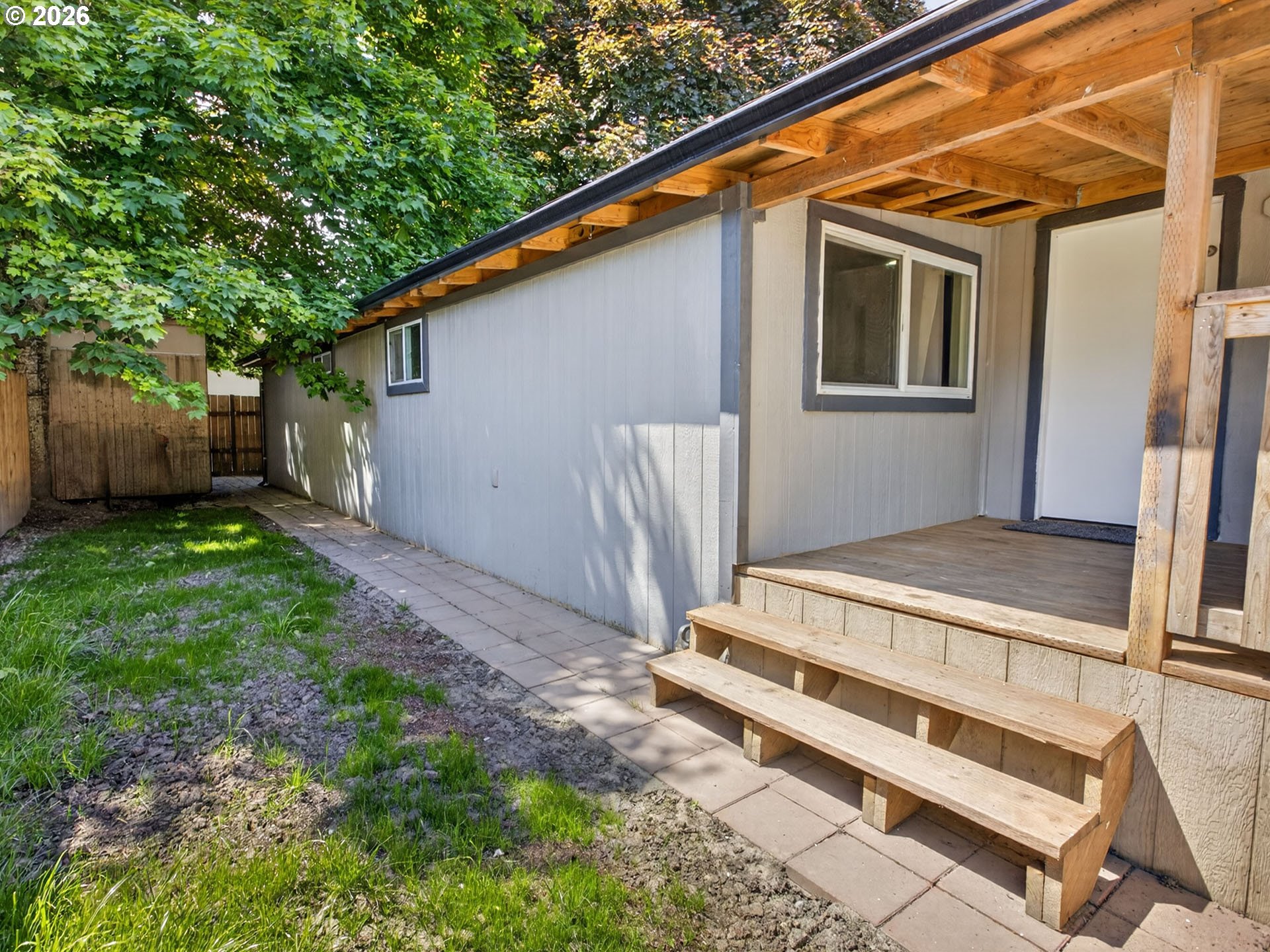 10405 Southwest Denney Road, Unit 31 Beaverton, OR 97008 - Photo 36 of 44 a backyard of a house with wooden floor and fence