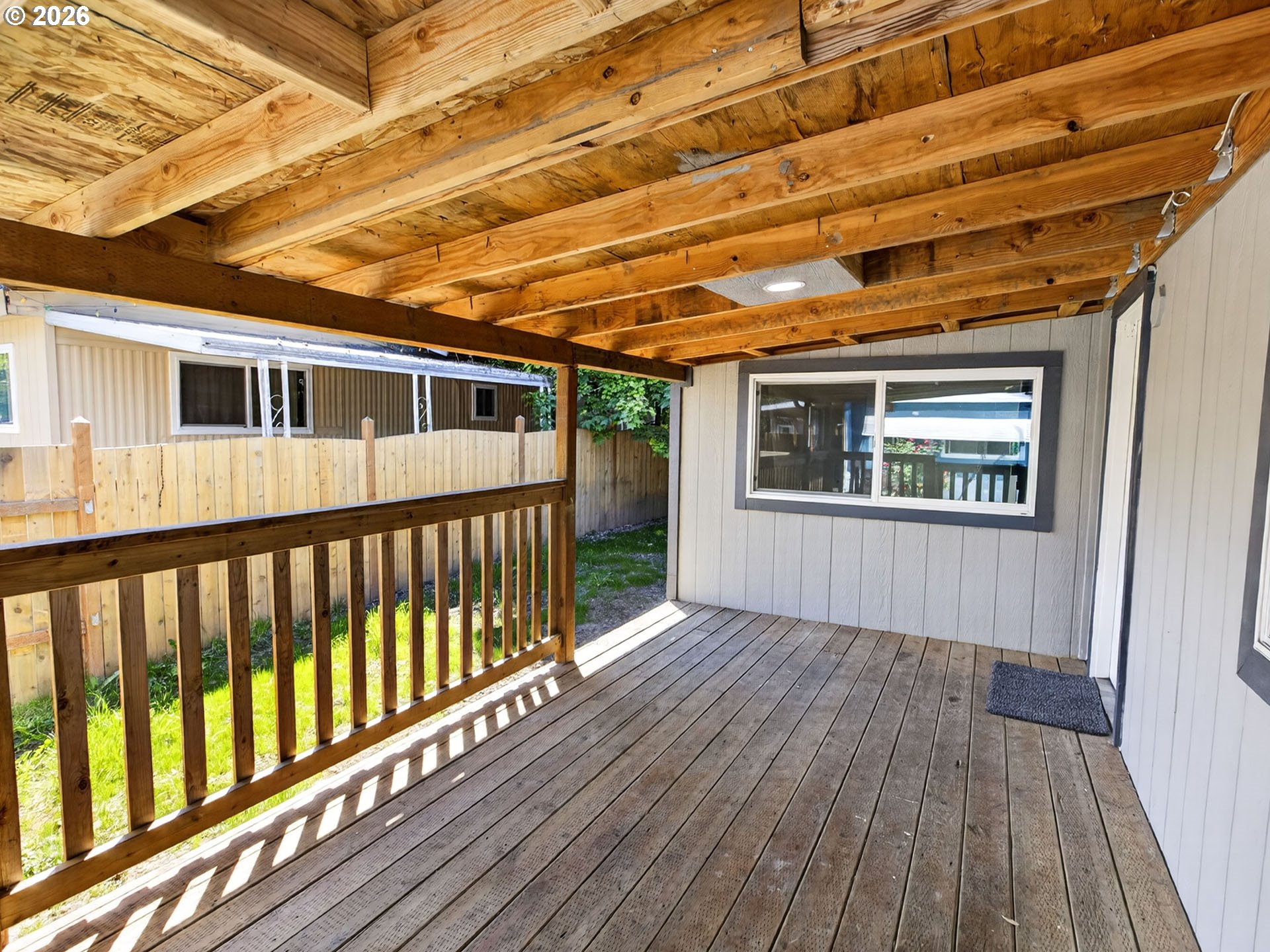 10405 Southwest Denney Road, Unit 31 Beaverton, OR 97008 - Photo 6 of 44 a porch with wooden floor in front of a house
