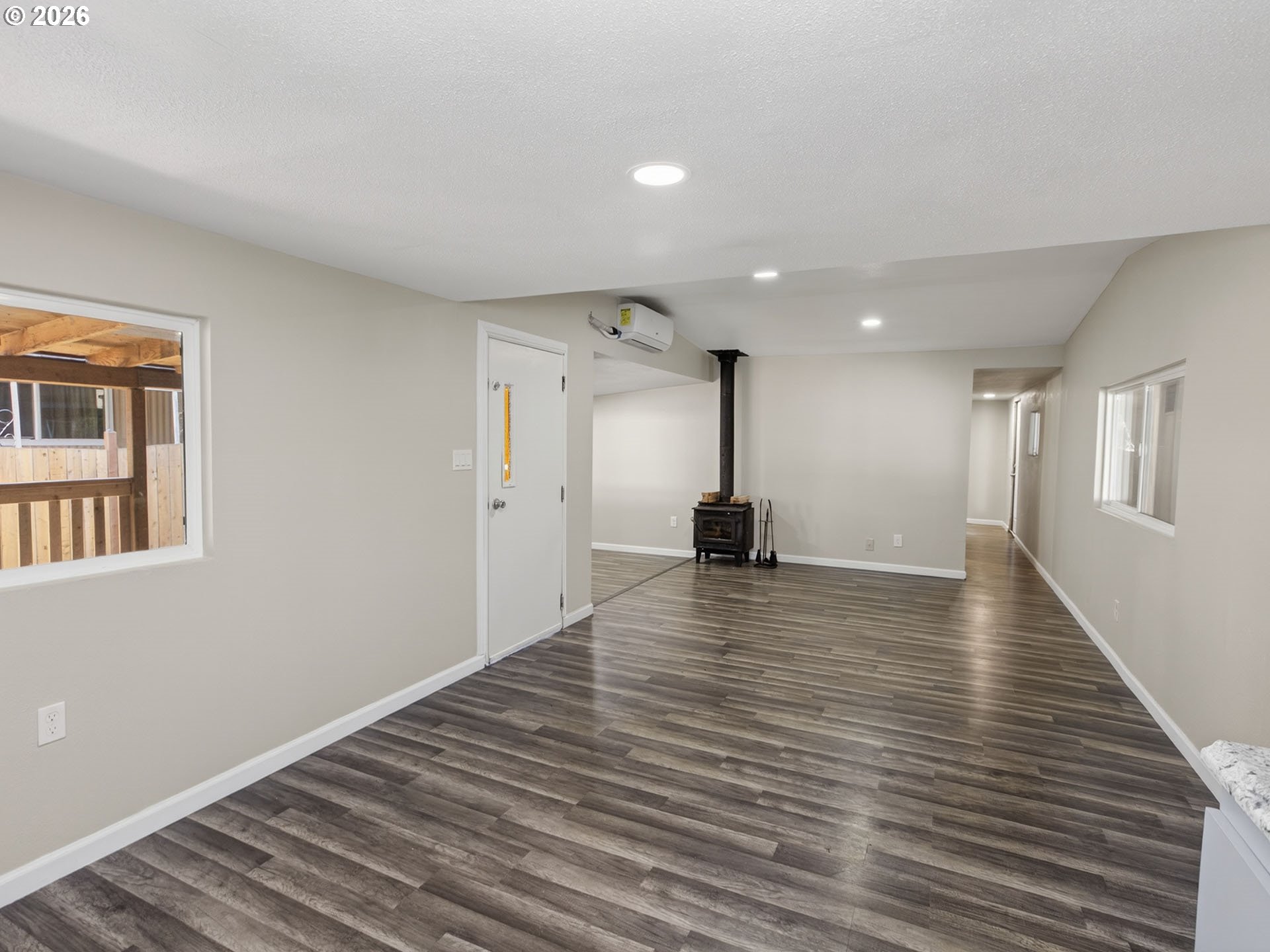 10405 Southwest Denney Road, Unit 31 Beaverton, OR 97008 - Photo 10 of 44 a view of an empty room with wooden floor and a window