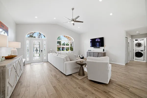 a living room with furniture and a wooden floor