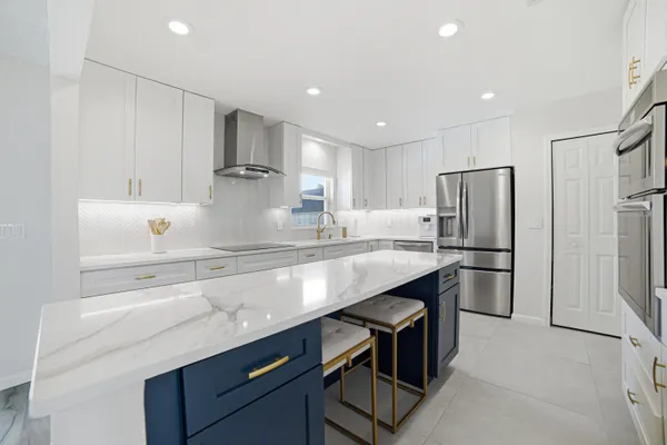 a kitchen with refrigerator a sink and cabinets