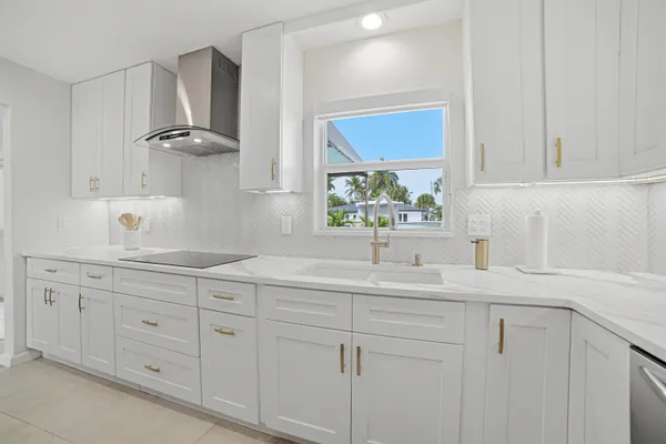 a kitchen with white cabinets and a sink