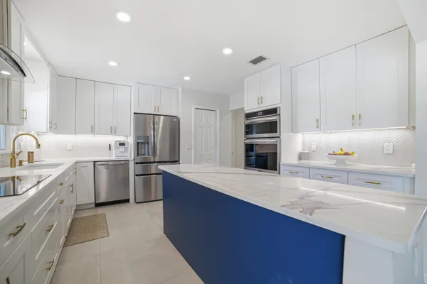 a kitchen with refrigerator cabinets and oven
