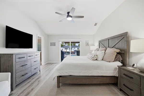 a bedroom with a large bed and a flat screen tv