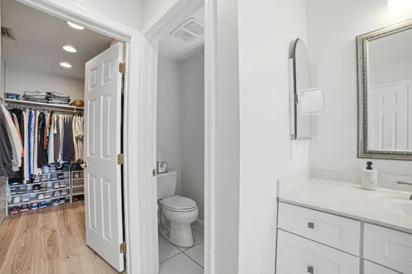 a bathroom with a toilet a sink and a mirror