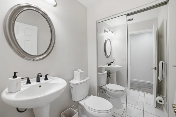 a bathroom with a toilet a sink and a mirror
