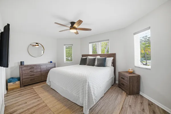 a bedroom with a bed dresser and a window