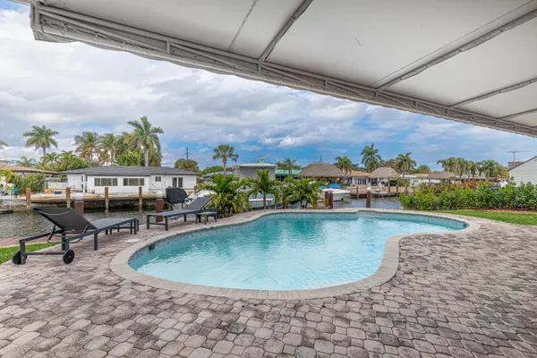 a view of a swimming pool with outdoor seating