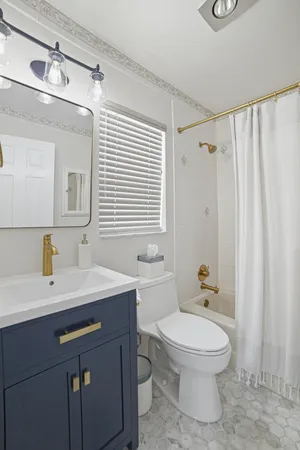 a bathroom with a sink a toilet and a mirror