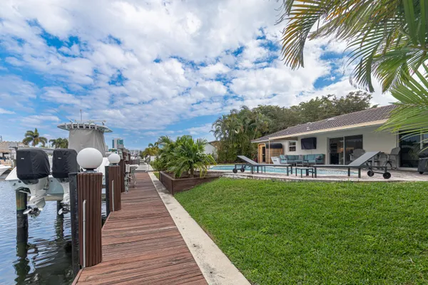 a front view of a house with garden and patio