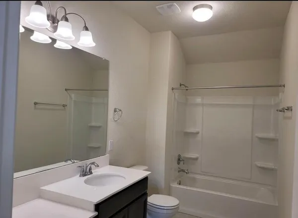 a view of kitchen with refrigerator and microwave
