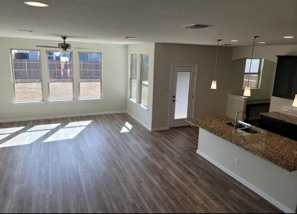 a view of kitchen with cabinets appliances and wooden floor
