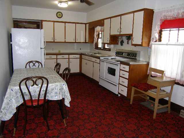 2284 East River Road Freeport, IL 61032 - Photo 3 of 9 a kitchen with a table chairs a stove a window and dining table