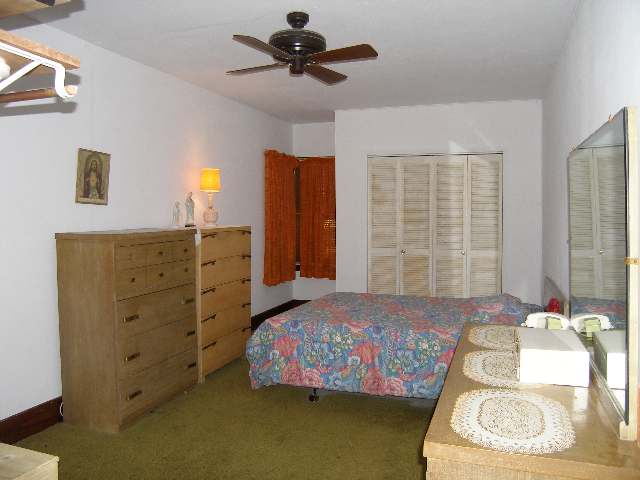 2284 East River Road Freeport, IL 61032 - Photo 4 of 9 a bedroom with a bed and a chandelier