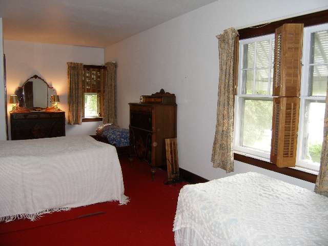 2284 East River Road Freeport, IL 61032 - Photo 5 of 9 a bedroom with a bed and wooden floor
