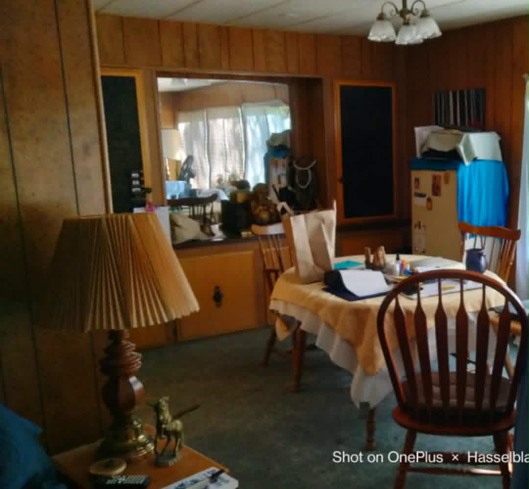 575 Kirkham Road Cave Junction, OR 97523 - Photo 17 of 45 a view of a dining room with furniture a chandelier and wooden floor
