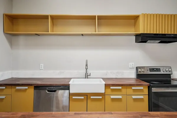 a kitchen with a sink stove and refrigerator