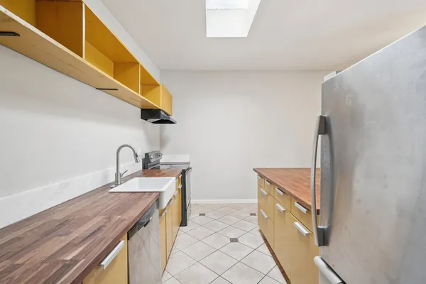 a open kitchen with a sink dishwasher a refrigerator and a stove