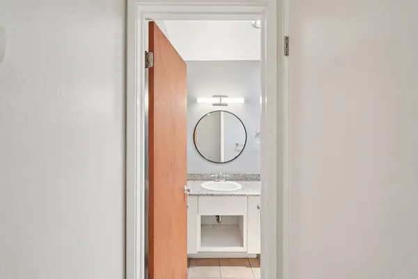 a bathroom with a sink vanity mirror and shower