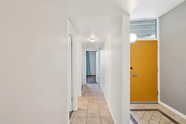 a backyard of a house with outdoor seating and trees