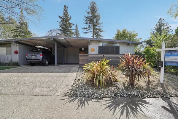 a view of a car park in front of a house