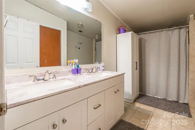 a bathroom with a double vanity sink and mirror