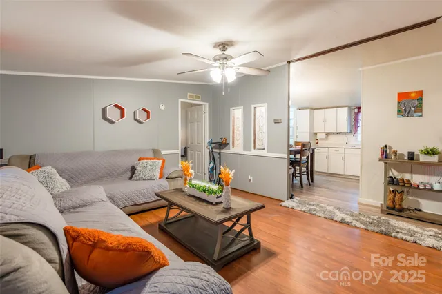a living room with furniture and kitchen view