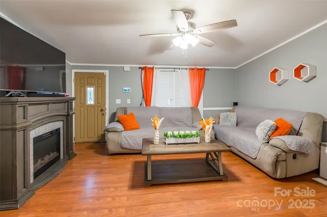 a living room with furniture a fireplace and a flat screen tv