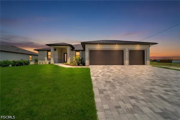 a front view of a house with a yard and garage