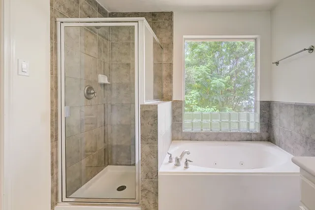 a bathroom with a bathtub and a shower