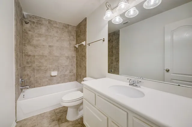 a bathroom with a sink a toilet and a bathtub