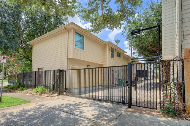 a view of a entrance gate of a house with wooden fence