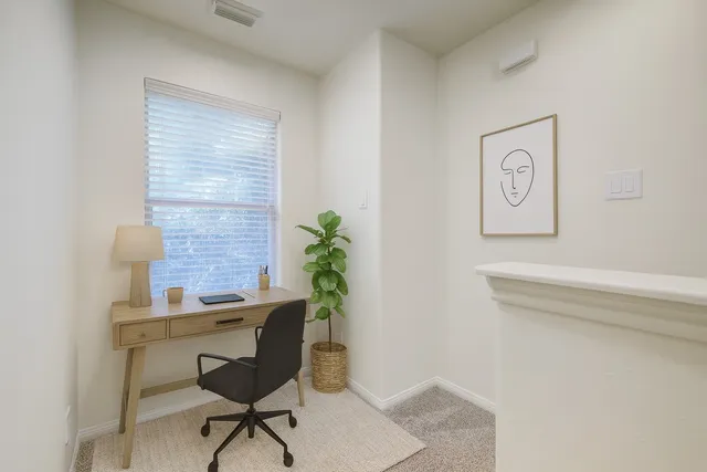 a workspace with furniture and a potted plant