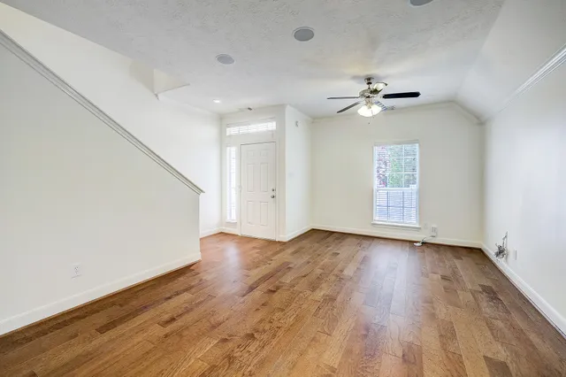 wooden floor in an empty room with a window
