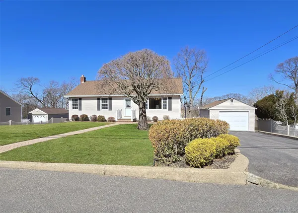 a front view of a house with a garden and yard