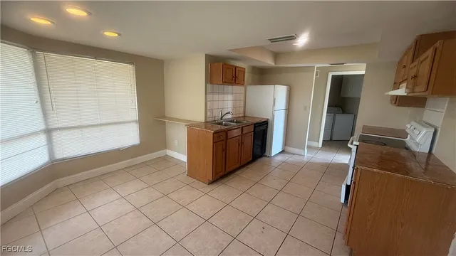 a kitchen with stainless steel appliances granite countertop a refrigerator and a stove
