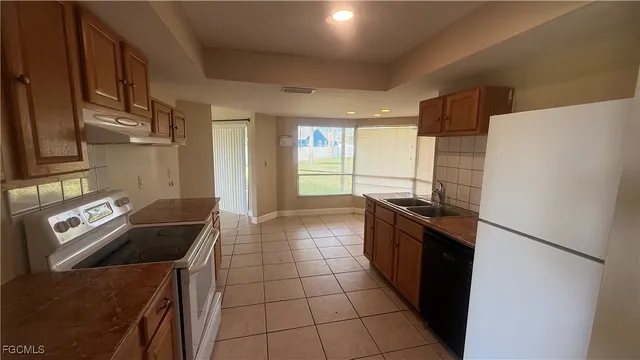 a kitchen with a sink a stove and refrigerator